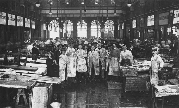 The interior of Billingsgate Market showing fishmongers and their stalls, London, c1918. Artist: Unknown