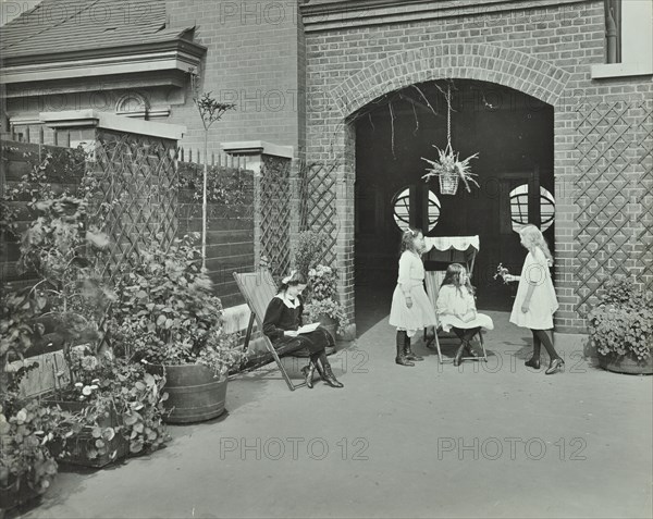 Girls relaxing in a roof top garden, White Lion Street School, London, 1912. Artist: Unknown.