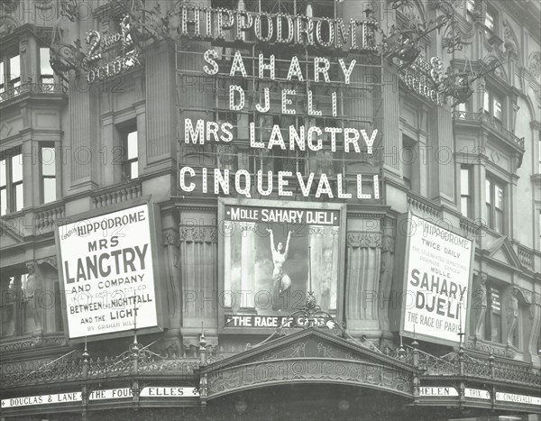 Illuminated advertisements on the front of The Hippodrome, Charing Cross Road, London, 1911. Artist: Unknown.