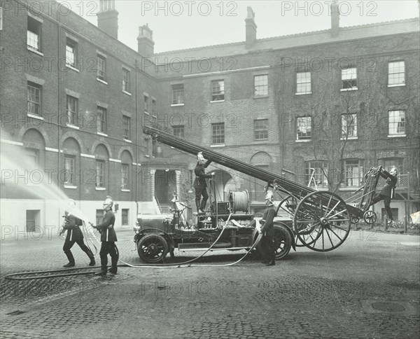 Fireman using a hose, London Fire Brigade Headquarters, London, 1910. Artist: Unknown.