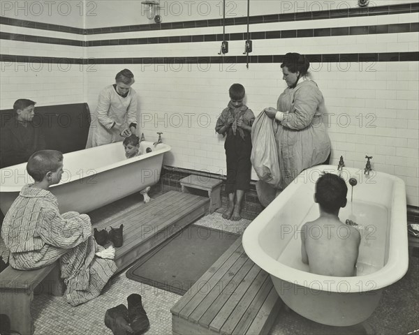 Attendants bathing boys at the Sun Court Cleansing Station, London, 1914. Artist: Unknown.