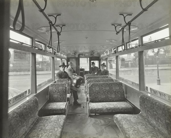 Men in hats and coats in the interior of an electric tram, London, 1933. Artist: Unknown.