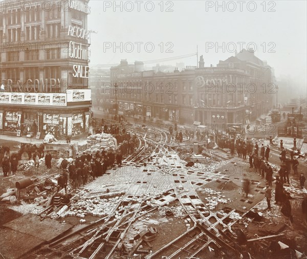 Laying tramlines at the junction of Whitechapel High Street and Commercial Road, London, 1907. Artist: Unknown.