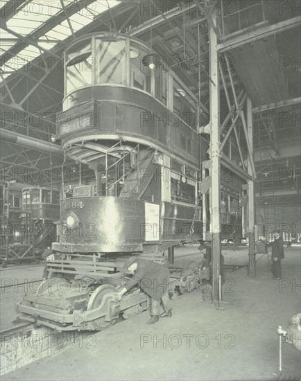 Men using a car lifting hoist at Charlton Central Repair Depot, London, 1932. Artist: Unknown.