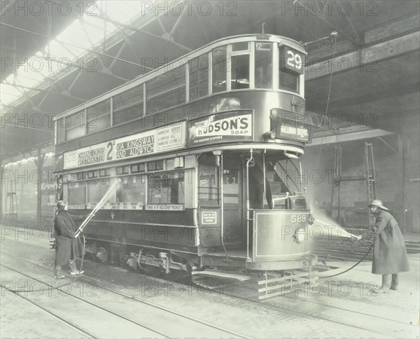 Transport workers washing a tram at the Holloway Car Shed, London, 1932. Artist: Unknown.