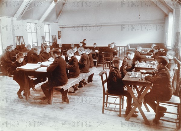 Boys playing dominoes and reading at the Boys Home Industrial School, London, 1900. Artist: Unknown.