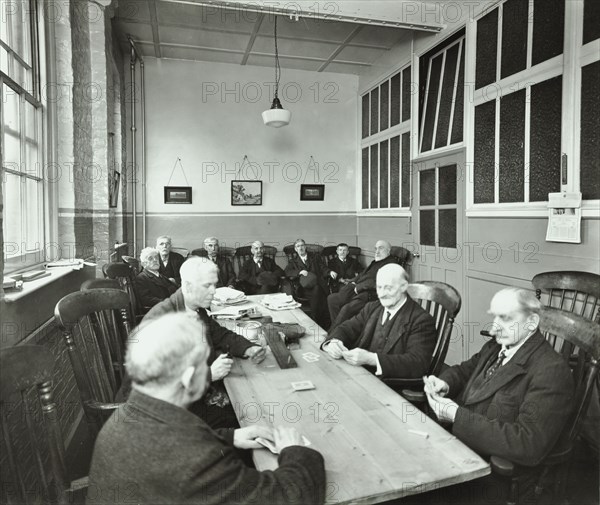 Pensioners playing cards in the Men's Day Room, Lambeth Home for Aged Poor, London, 1935. Artist: Unknown.