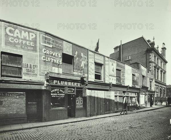 Row of shops with advertising hoardings, Balls Pond Road, Hackney, London, September 1913. Artist: Unknown.