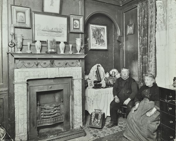 Elderly couple in Victorian interior, Albury Street, Deptford, London, 1911. Artist: Unknown.