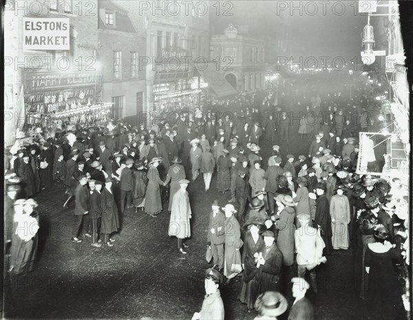 Crowds in Deptford High Street shopping after dark, London, 1913. Artist: Unknown.