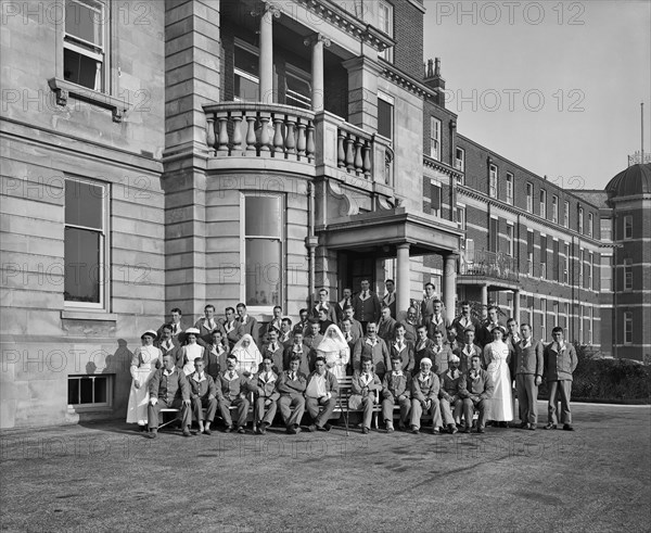 Nurses, nuns and military patients outside St Andrew's Hospital, Dollis Hill, London, October 1916