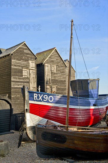 Fishing boat on the beach in front of the 'net shops', Hastings, East Sussex, c1980-c2017