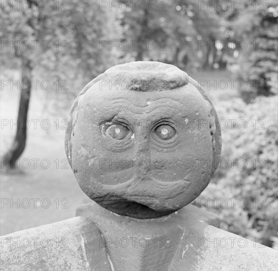 Carved Victorian stone head on a garden wall, Speke Hall, Liverpool, Merseyside, c1945-c1980