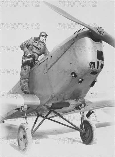 Aerial photographer getting into an aeroplane, c1930s