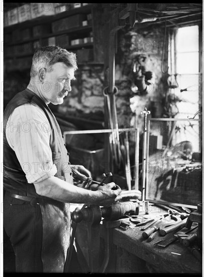 Mr Jefferies at work in the forge, Southrop, Cotswolds, Gloucestershire, 1938