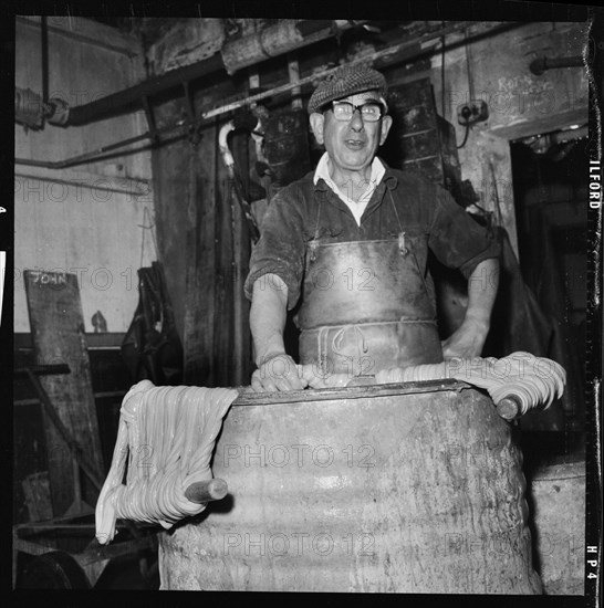 Portrait of a worker in a factory involved in the processing of animal guts, 1966-1974