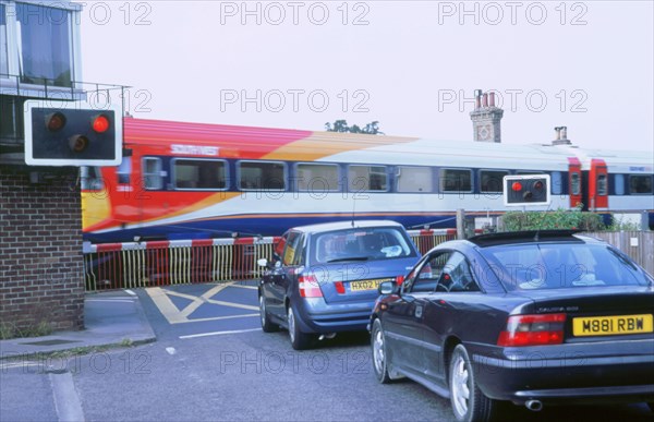 Traffic queue at level crossing in Brockenhurst, Hampshire. Artist: Unknown.