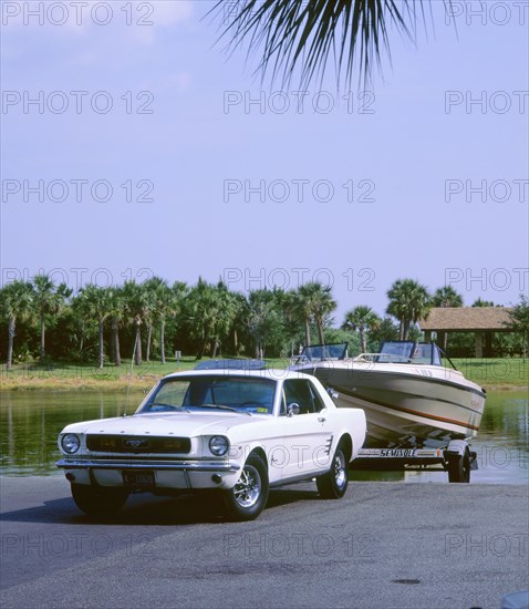 1967 Ford Mustang towing a boat. Artist: Unknown.