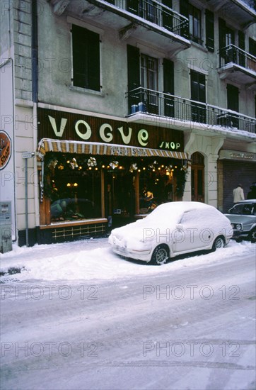 Car covered in snow in French street. Artist: Unknown.