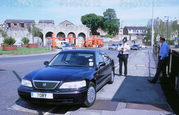 Policeman checking driver documents. Artist: Unknown.