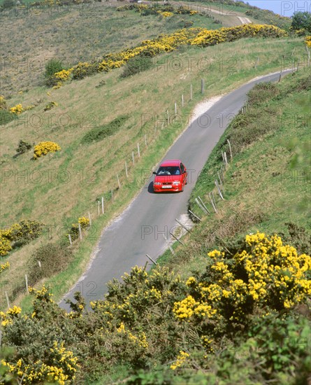 1996 Suzuki Baleno GS Sport on winding country lane,Dorset. Artist: Unknown.