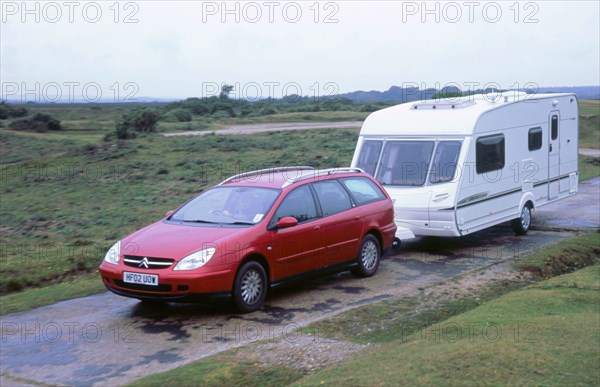 2002 Citroen C5 estate towing caravan. Artist: Unknown.