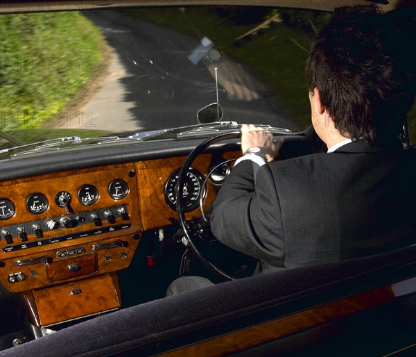 Chauffeur driving 1970 Daimler vanden plas DS 420 limousine. Artist: Unknown.