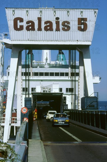 Cars boarding ferry at Calais. Artist: Unknown.