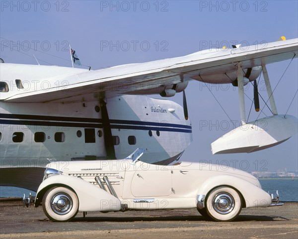 1935 Auburn 851 speedster with Sunderland flying boat. Artist: Unknown.