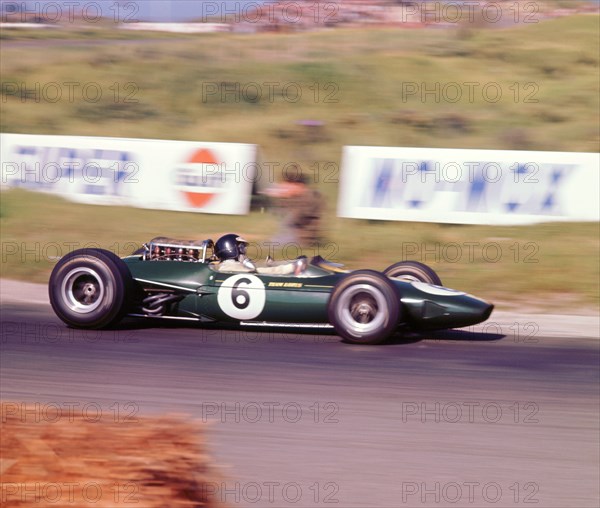 James Clark driving a 1966 Lotus 33 Climax V8. Artist: Unknown.