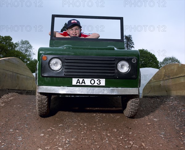 Children driving a toy Land Rover. Artist: Unknown.