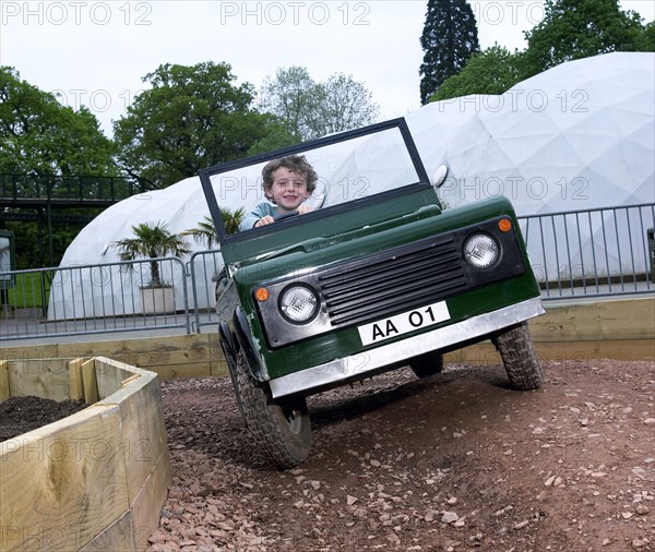 Child driving a toy Land Rover. Artist: Unknown.