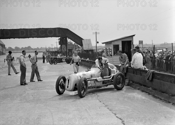 Kay Petre in an Austin 7 works team racing car, Brooklands, 1937. Artist: Bill Brunell.