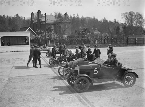 Morris, Morgan and Crouch cars on the start line of a motor race, Brooklands, 1914. Artist: Bill Brunell.