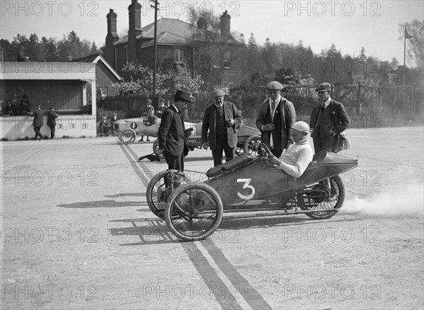 Morgan and Crouch cars on the start line of a motor race, Brooklands, 1914. Artist: Bill Brunell.