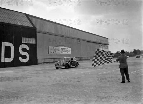 HJ Ripley's SS Jaguar taking the chequered flag, MCC Members Meeting, Brooklands, 10 September 1938. Artist: Bill Brunell.