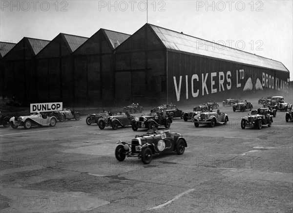 Cars racing at the MCC Members Meeting, Brooklands, 10 September 1938. Artist: Bill Brunell.