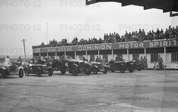 Cars at the start of a race at a JCC Meeting, Brooklands. Artist: Bill Brunell.