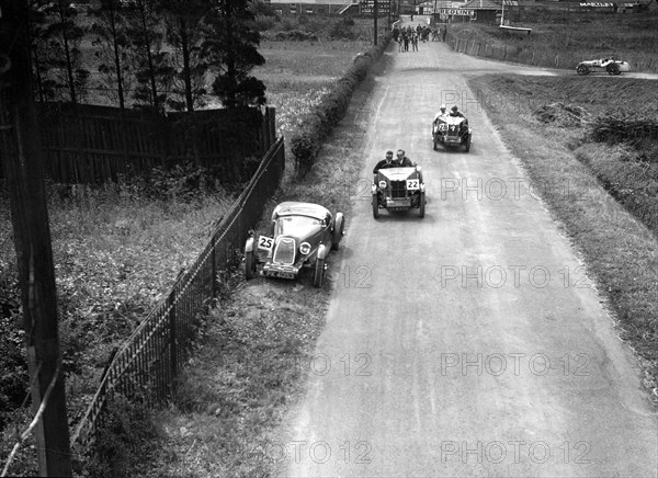 Two MG M types passing a broken down 1928 Alta Prototype, JCC Members Day, Brooklands, 4 July 1931. Artist: Bill Brunell.