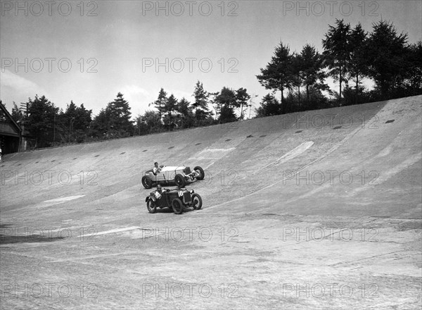 Invicta and Austin Ulster racing on the Members Banking at Brooklands. Artist: Bill Brunell.