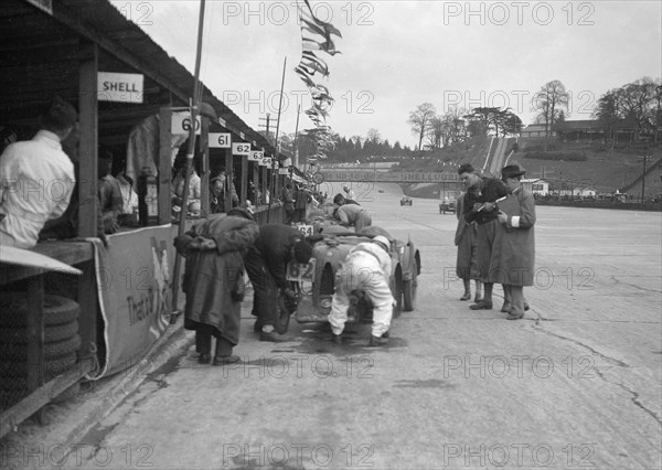 N Black and CW Fiennes' MG C type in the pits at the JCC Double Twelve race, Brooklands, May 1931. Artist: Bill Brunell.