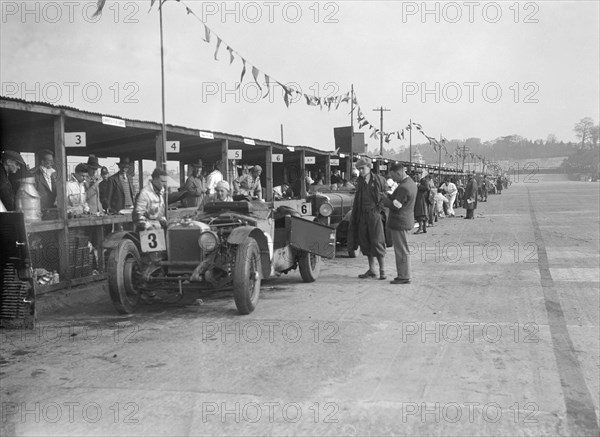 Invicta of FH Cairnes and George Field in the pits at the JCC Double Twelve race, Brooklands, 1931. Artist: Bill Brunell.