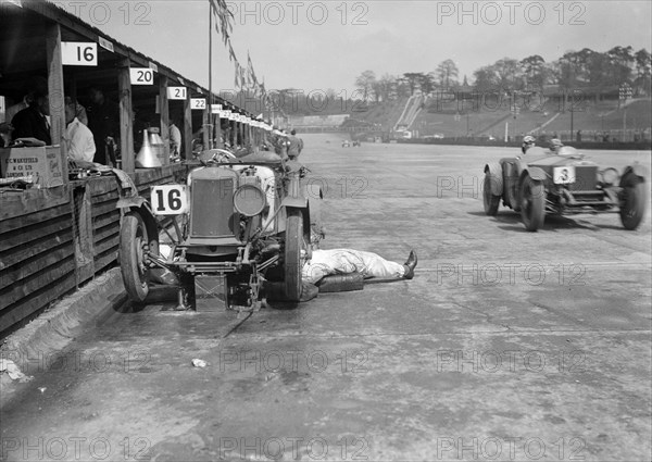 Mechanic working on a Lea Francis J type at the JCC Double Twelve race, Brooklands, May 1931. Artist: Bill Brunell.