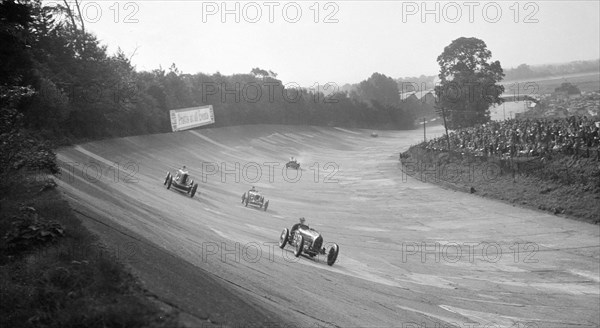 Bugatti Type 54 leading a Talbot 90 on the banking at Brooklands, 1930s. Artist: Bill Brunell.