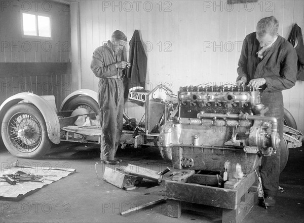 Mechanics working on Raymond Mays' 4500 cc Invicta car. Artist: Bill Brunell.