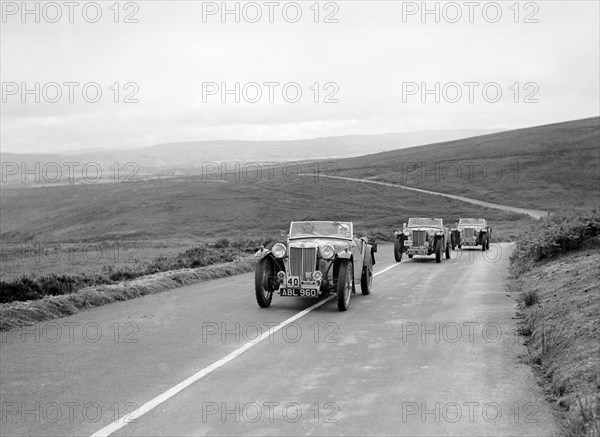 Three MG TAs competing at the MCC Torquay Rally, July 1937. Artist: Bill Brunell.