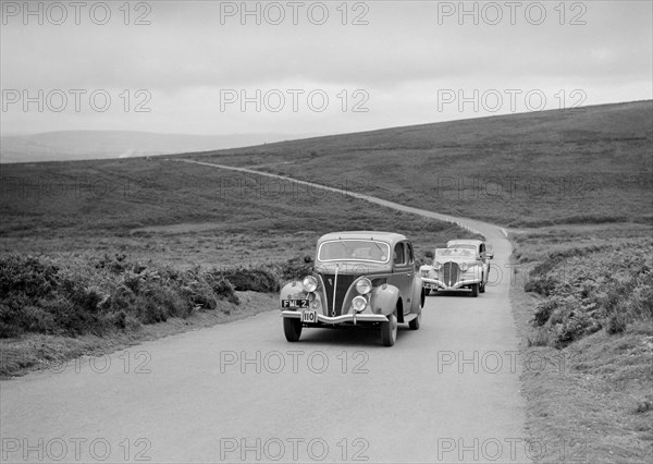 GM Denton's Ford V8 leading the Delahaye of DA Loader at the MCC Torquay Rally, July 1937. Artist: Bill Brunell.