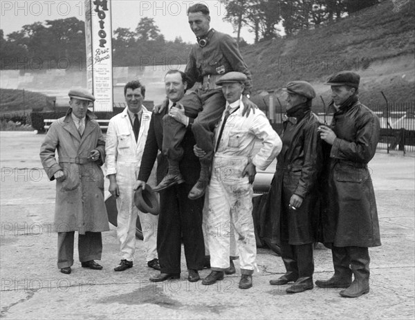 Leon Cushman being carried aloft after making a successful speed record attempt, Brooklands, 1931. Artist: Bill Brunell.