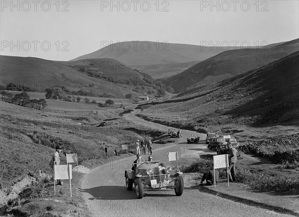 K Hutchison's winning Allard Special leading R Fielding's Jaguar SS at the Blackpool Rally, 1939. Artist: Bill Brunell.