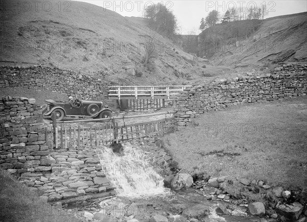 Kitty Brunell road testing a MG 18/80, Tan Hill, Yorkshire, April 1931. Artist: Bill Brunell.